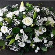 All white casket with mixed flowers 4ft